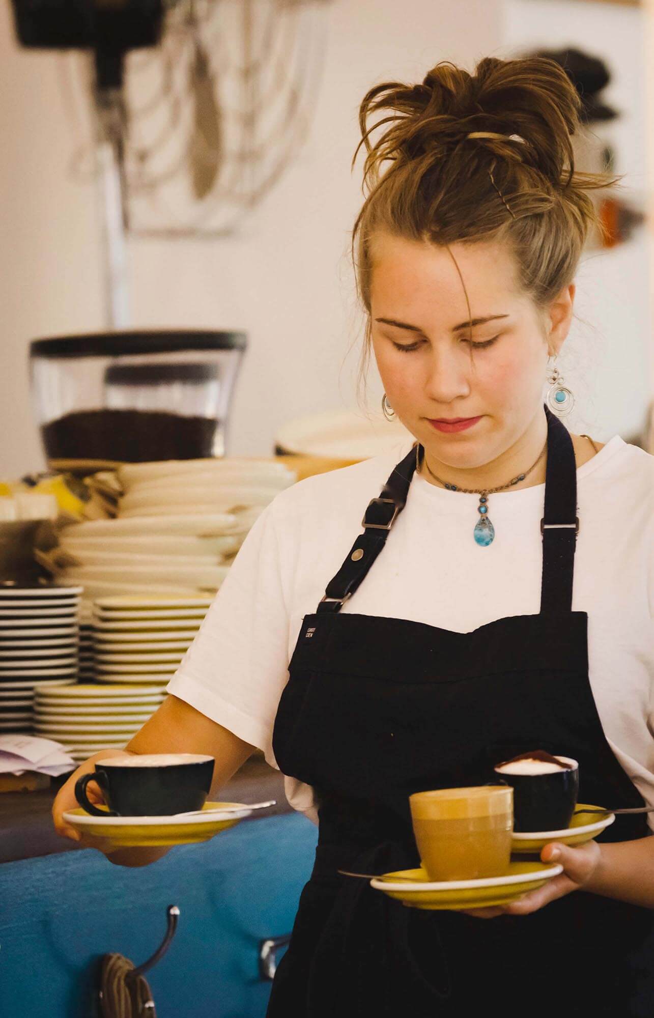A waitress carries coffees